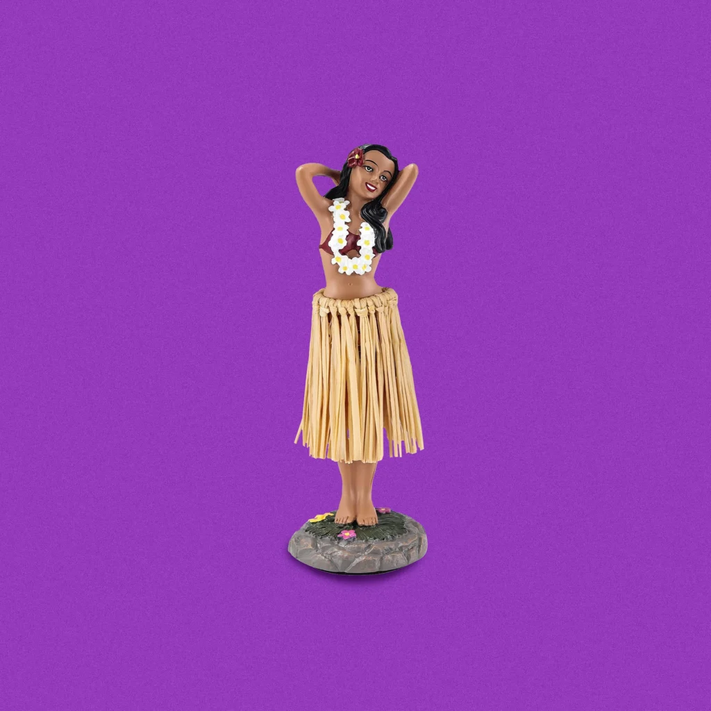 Hula girl dashboard bobble head doll on purple background.
