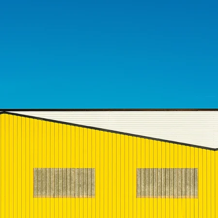 Modern yellow building with blue sky.