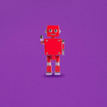 Red Robot isolated on a purple background.
