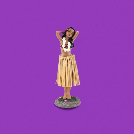 Hula girl dashboard bobble head doll on purple background.